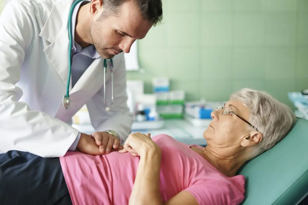 pain management doctor treating a senior patient.