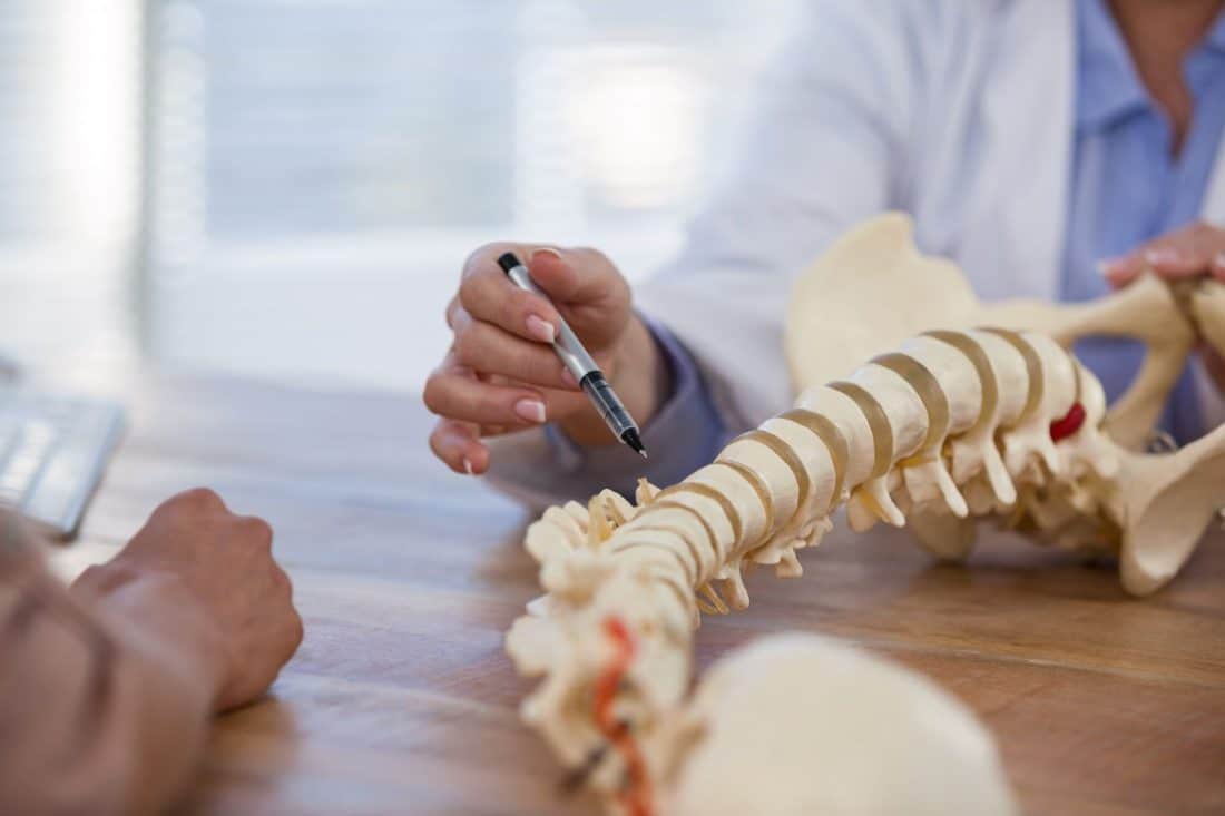 The doctor explaining Chiropractic pine to patient at Houston, TX
