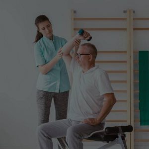 male senior's post-surgical physical rehabilitation with a female therapist