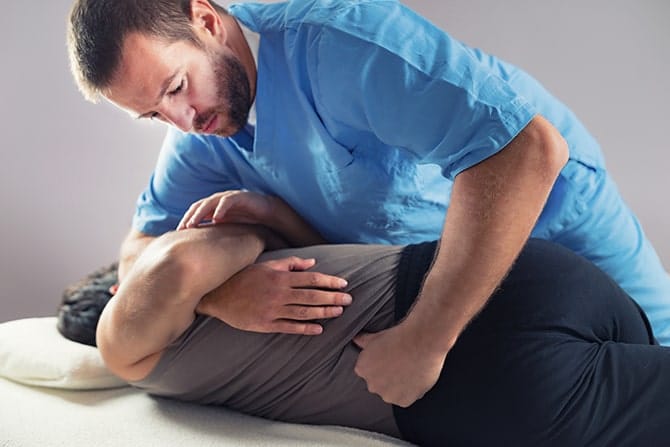 Chiropractor adjusting a patient's back