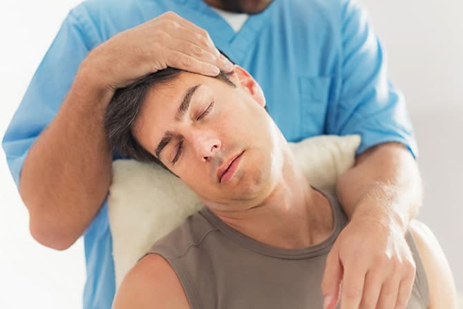 physiotherapist working with patient neck