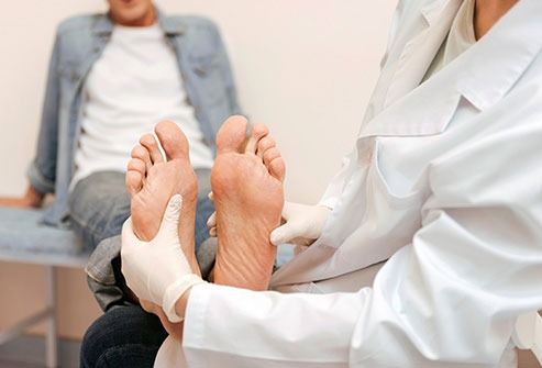 chiropractor examining a diabetic patient's foot