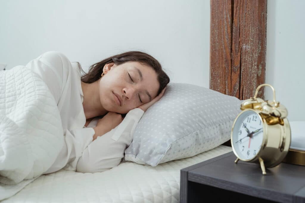 Calm woman sleeping on pillow in bedroom
