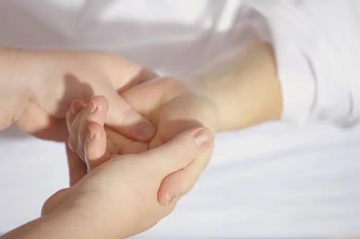 Chiropractor massaging a patient's hand