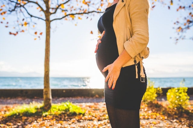 pregnant woman on a park near the sea