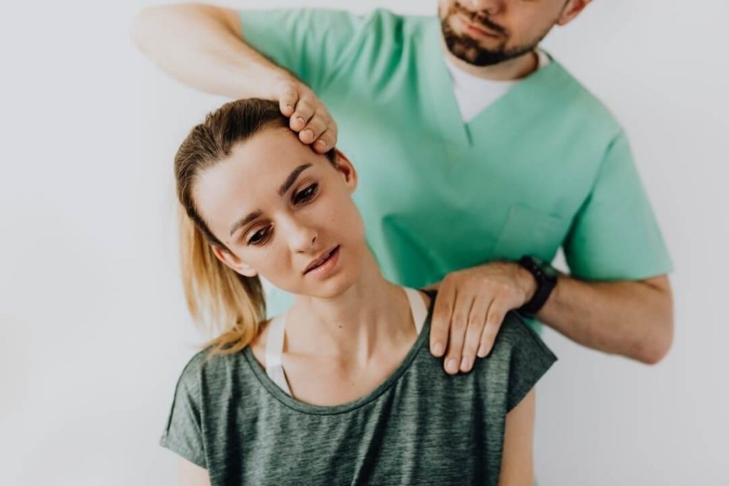 female patient getting chiropractic care from a male chiropractor