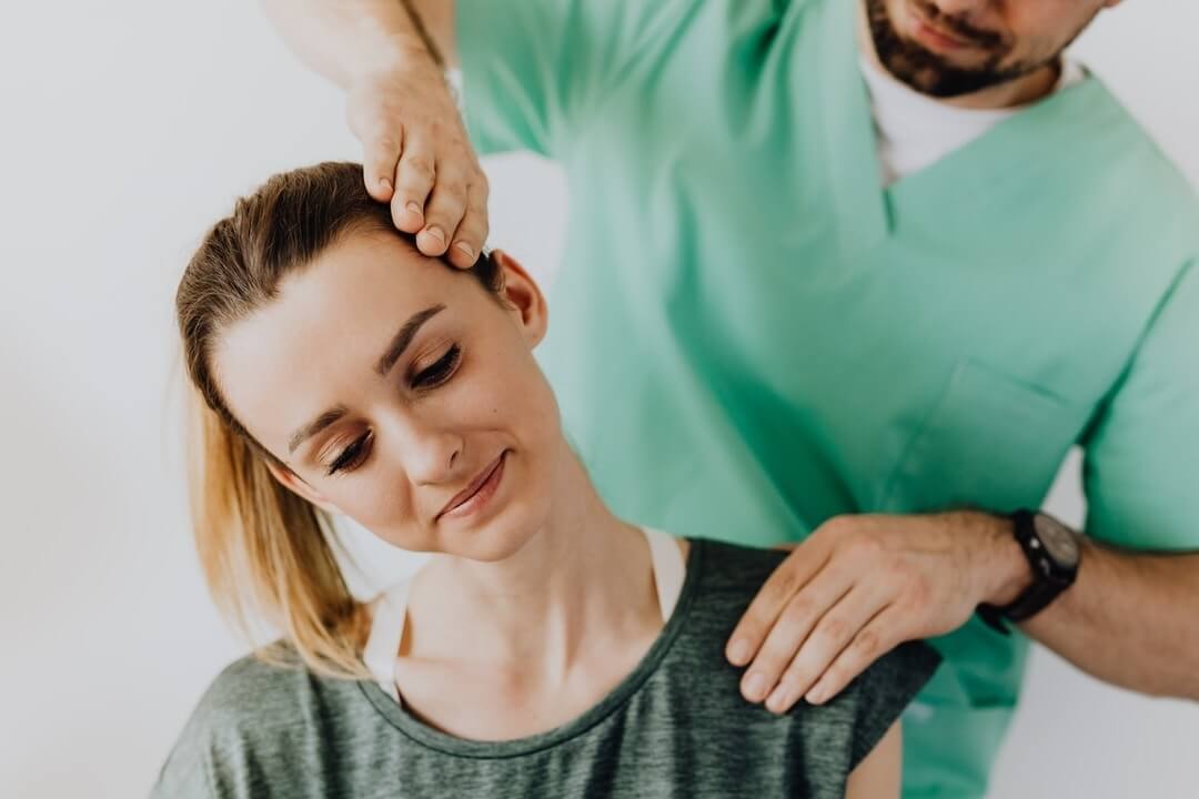 femmale patient getting her neck adjustments from a chiropractor
