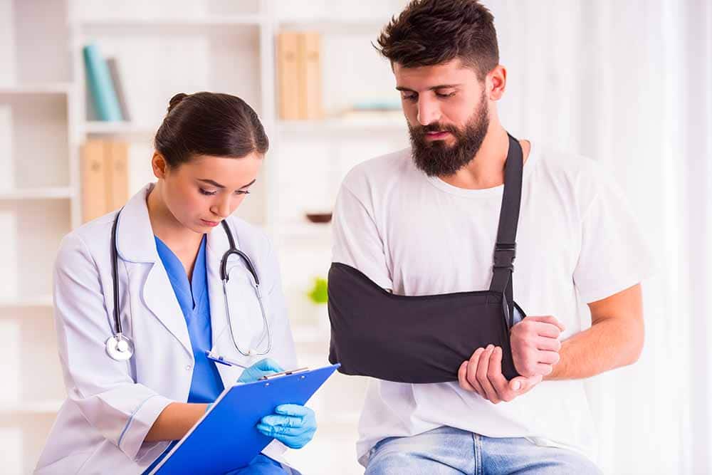 injured male worker in check up with a chiropractor