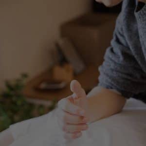 cropped image of a therapist massaging a patient's back using his elbow