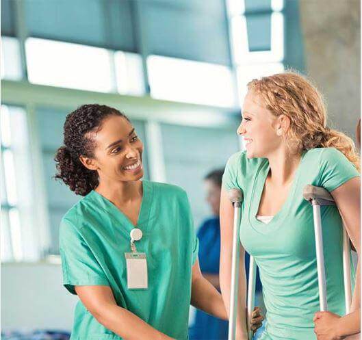 woman on crutches helped by a female nurse