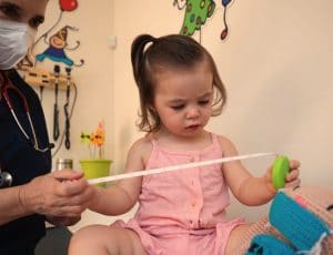 a kid chiropractor examining a child 