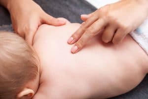 Months old baby getting chiropractic treatment