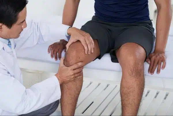 A Chiropractor is doing some knee evaluation to the patient at Woodlands, TX