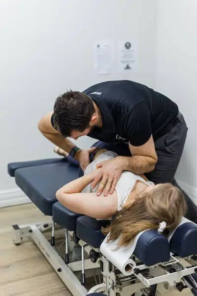 Chiropractor doing the flexion distraction technique to a female patient