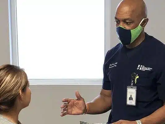 Houston Spine and Rehab chiropractor talking with a female patient