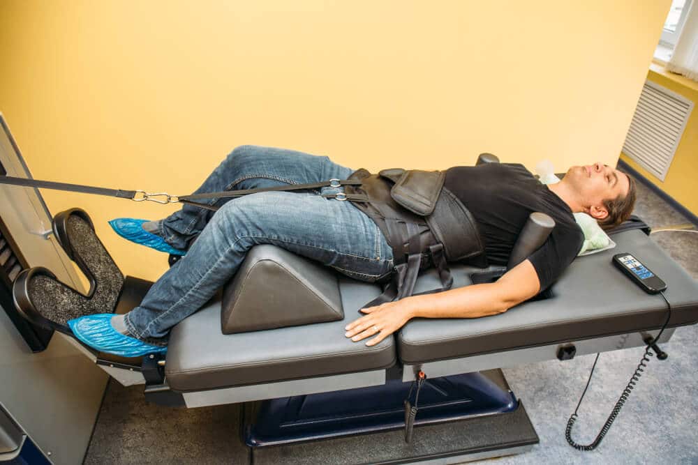 male patient getting spinal decompression therapy in a clinic