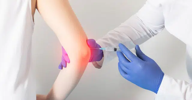 Doctors giving a patient a joint injection