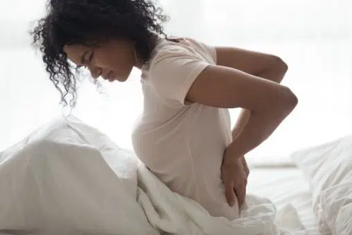 Young woman having a backache and over all fatigue