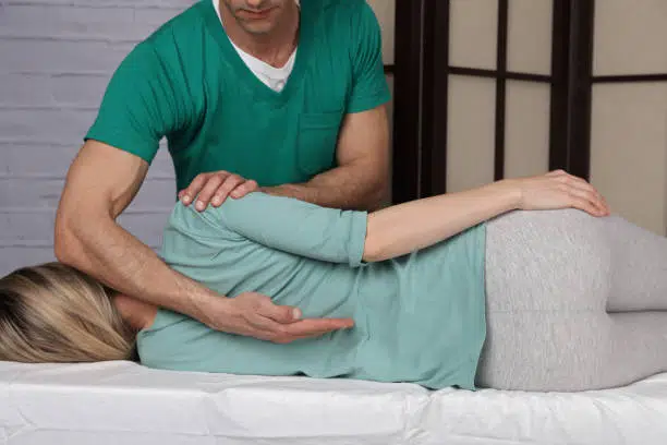 Woman having chiropractic back adjustment. 