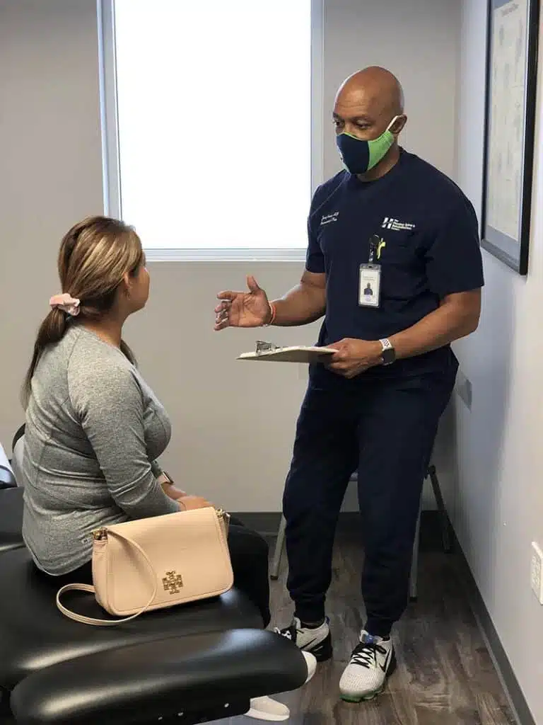Chiropractor is having a consultation with a patient regarding a surgery