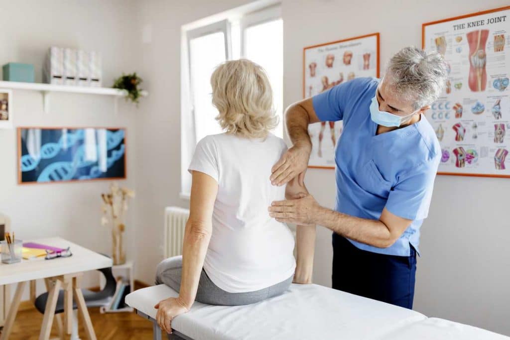 Senior woman having an Active Release Technique treatment in the clinic 