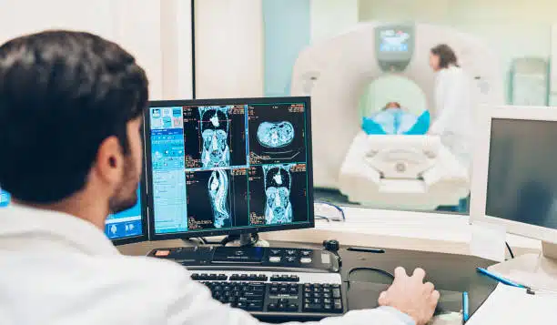 Doctor looking at a monitor with patient's MRI scan results