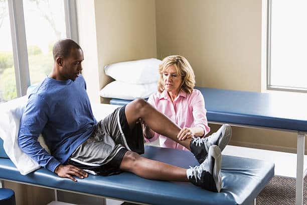 Man sitting on a clinic bed after getting a orthopedic surgery