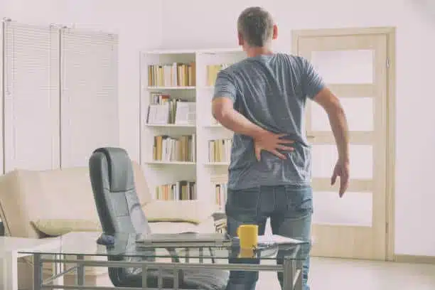 Man suffering from severe back pain at home