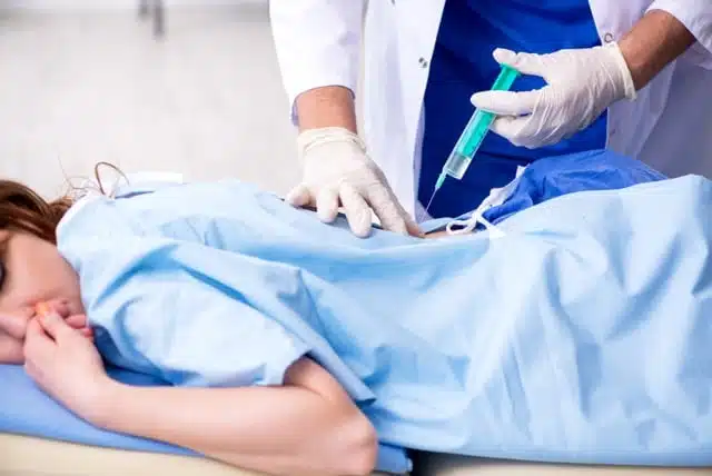 Female patient is getting a regenerative medicine for her back pain