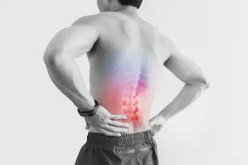 Shirtless man touching his back due to pain cause by bask surgery with red highlight, on white background.