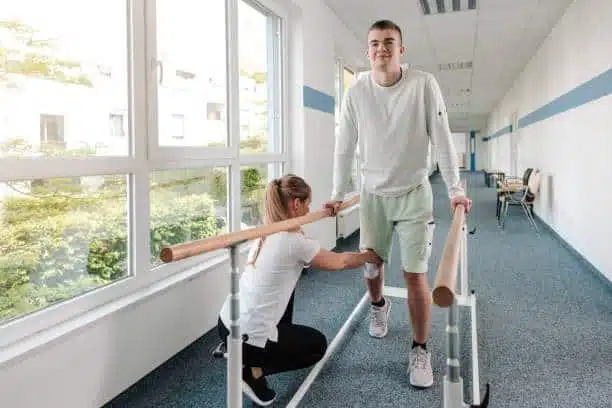 Young man doing some physical therapy after suffering from knee injury