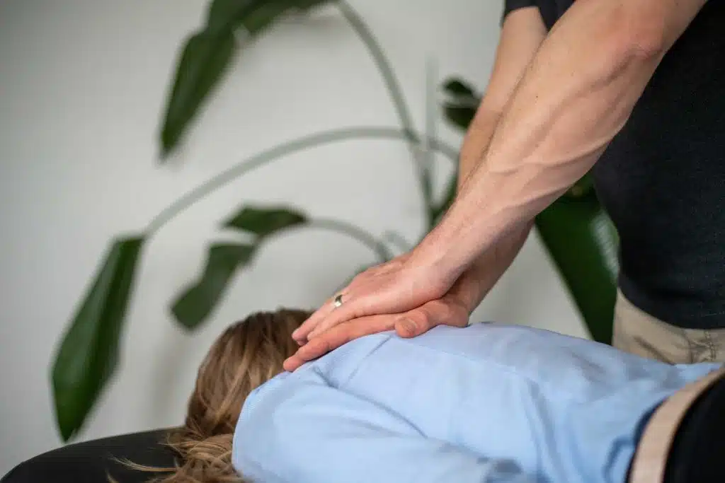 Chiropractor is treating a patients back suffers from bulging Disc.