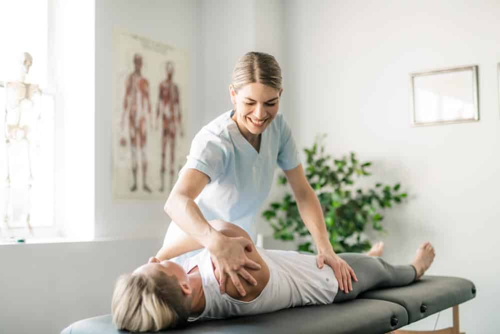Female chiropractor doing some chiropractic adjustment to the patient.
