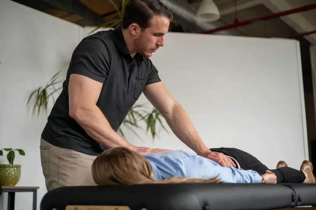 Chiropractor is treating a patients back suffers from Back pain.