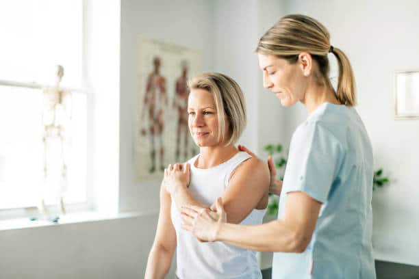 Modern rehabilitation physiotherapy worker with a woman client doing some physical therapy treatment.