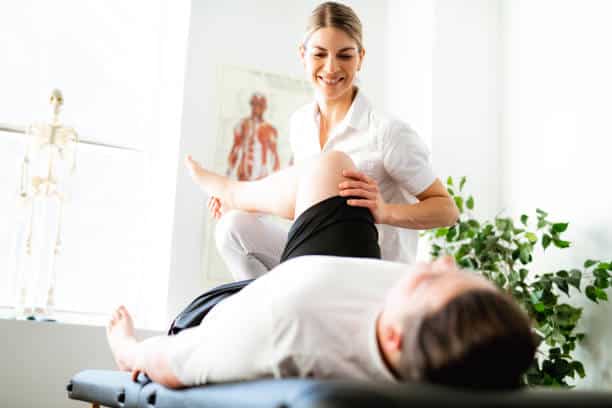 Physiotherapist helping a patient with his physical therapy treatment.