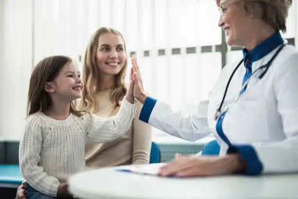 Chiropractor is having an pediatric evaluation with a young patient.