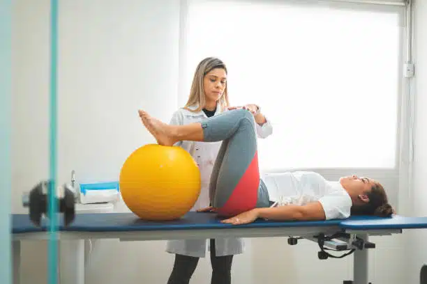 Physiotherapist helping a patient with her physical therapy treatment.