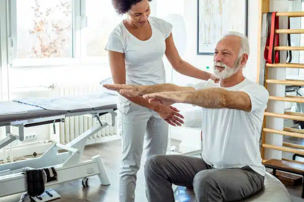 Physiotherapist helping a patient with his physical therapy treatment.