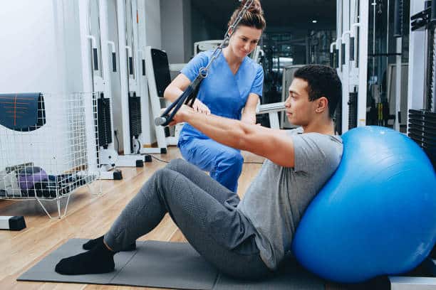 Physiotherapist helping a patient with his physical therapy treatment.