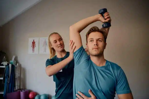 Physiotherapist helping a patient with his physical therapy treatment.