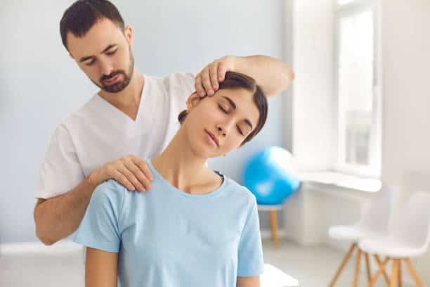 chiropractor doing neck stretching massage to the patient.
