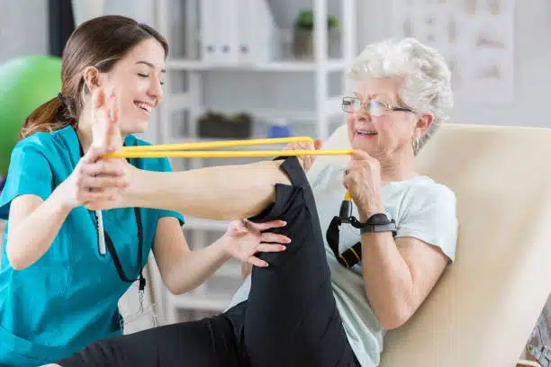 Female Physiotherapist helping a senior patient with his physical therapy treatment.