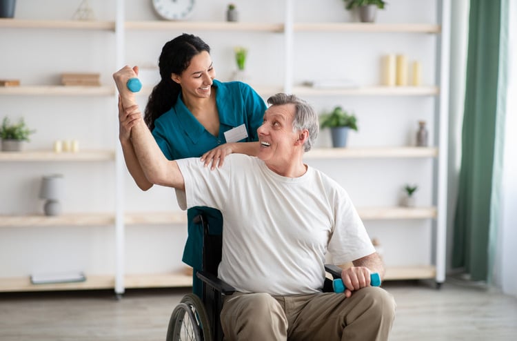 Physiotherapist helping a senior patient with his physical therapy treatment.