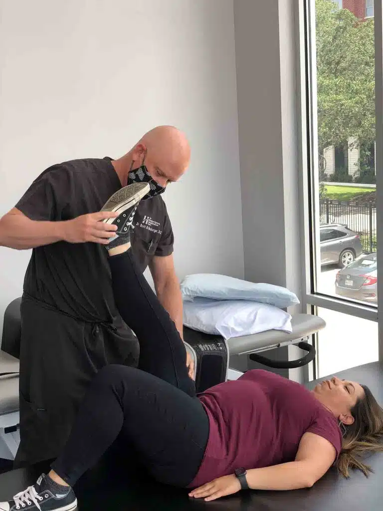 Chiropractor at Houston Spine and Rehabilitation doing some chiropractic adjustment to the patient.