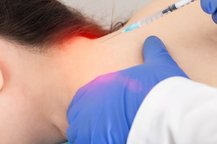 Doctor doing some Occipital Nerve Block injection to the patient.