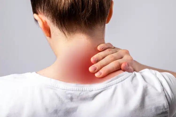 Woman holding her neck suffering from intense neck pain.