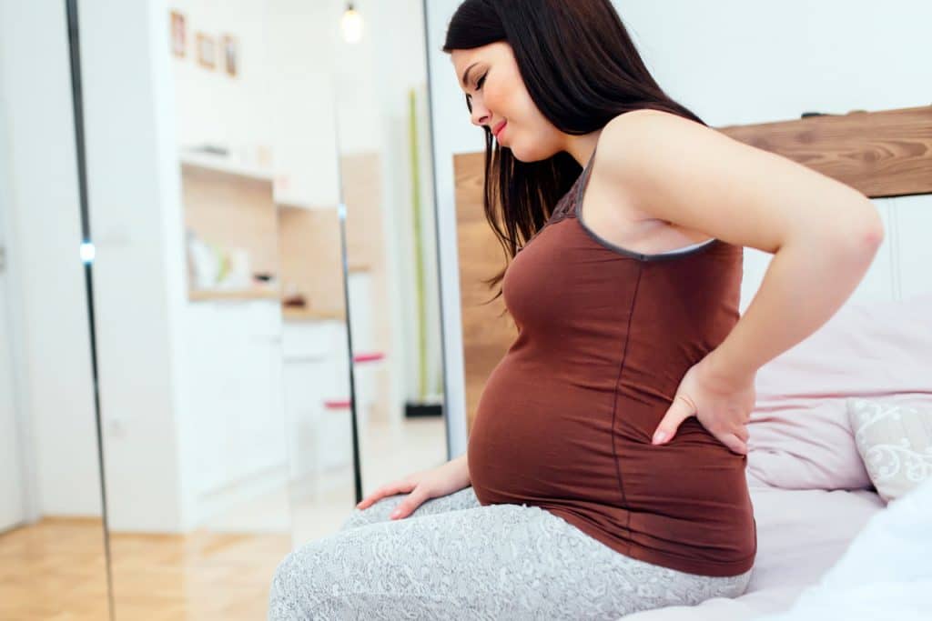 Pregnant woman suffers from back pain during pregnancy.