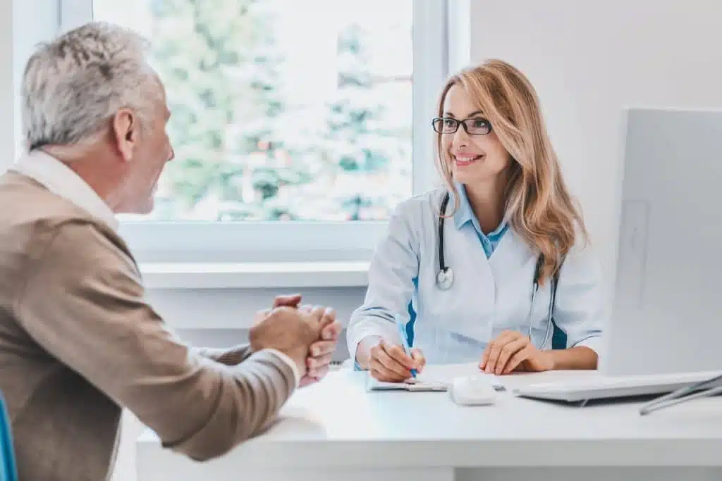 Patient talking to a chiropractor regarding her health insurance.