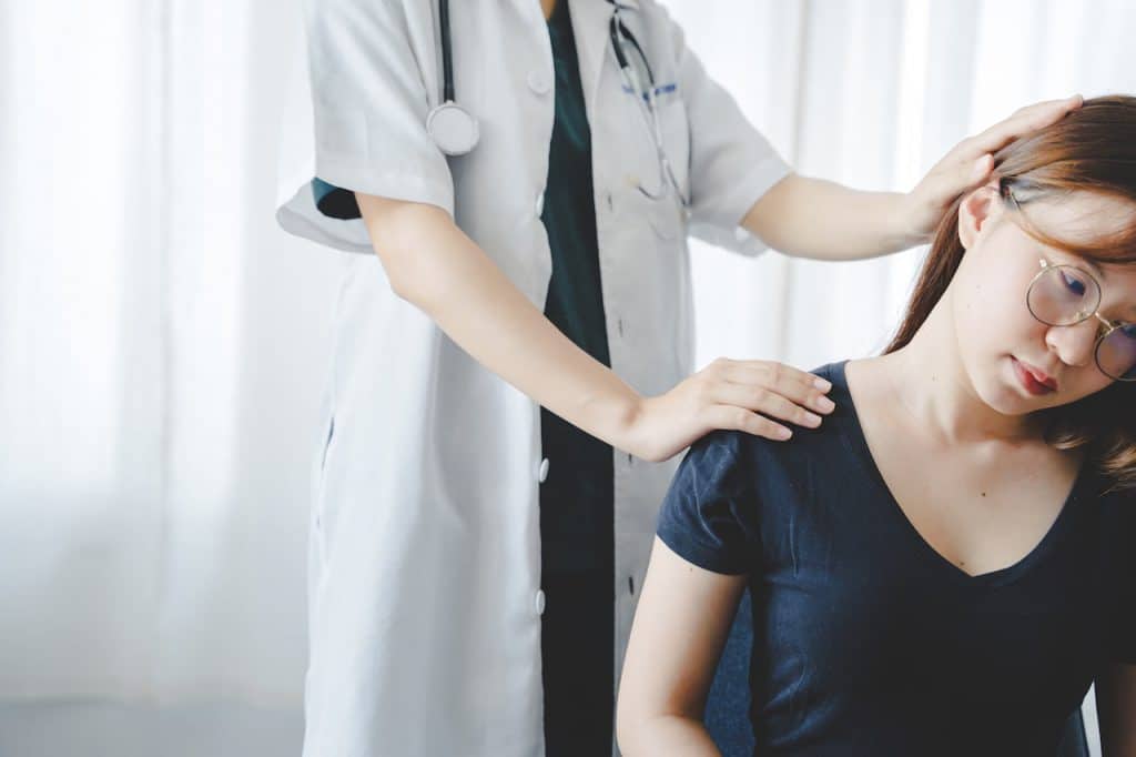 Chiropractor doing some chiropractic neck adjustment to the patient.